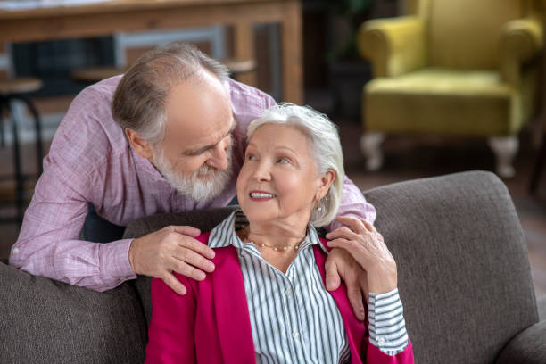 istock Elderly grey-haired couple looking at each other 1209299629