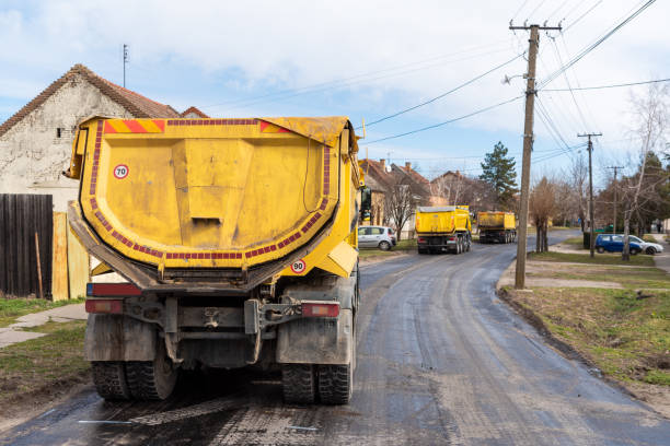 istock Workers with machines and rollers pave the new road 1209304133