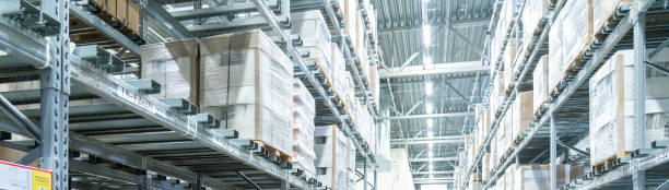 istock Rows of shelves with boxes in modern warehouse 1209304334