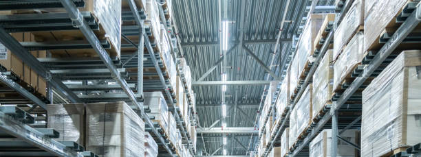 istock Rows of shelves with boxes in modern warehouse 1209304340