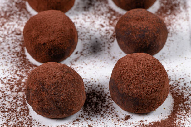 istock Fine chocolate truffles on white ceramic plate. 1209309435