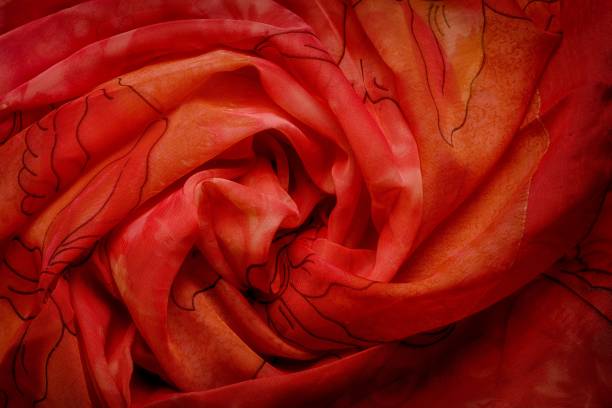 istock Red wavy silk drapery, crumpled fabric swirl rose shape. 1209309498