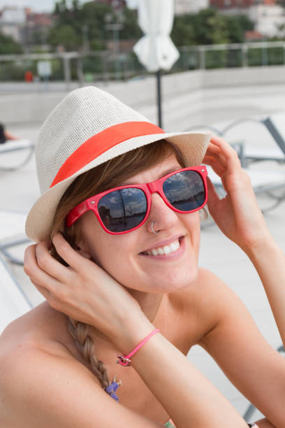 istock Cute young woman enjoying summertime at the poolside. 1209311156