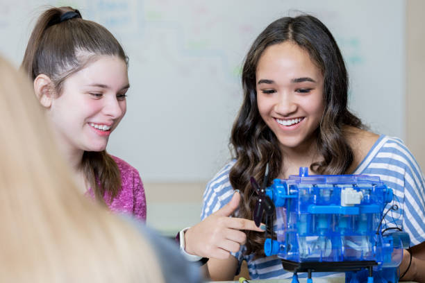istock Female high school students working on model motor 1209312010