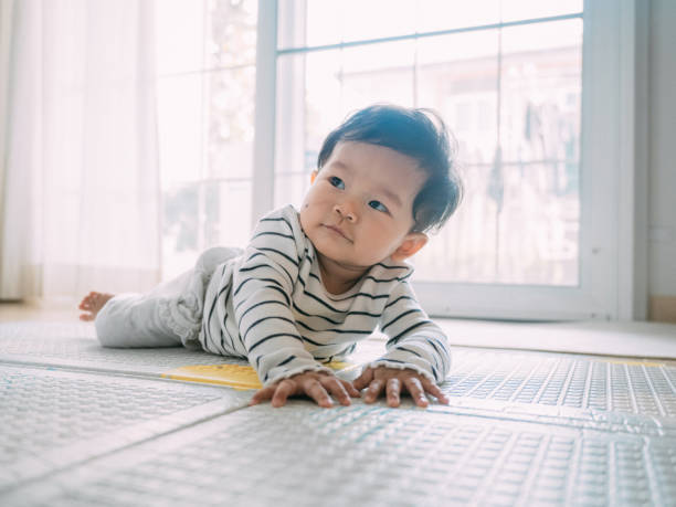 istock Baby boy smiling and laughing on the mat. 1209313283