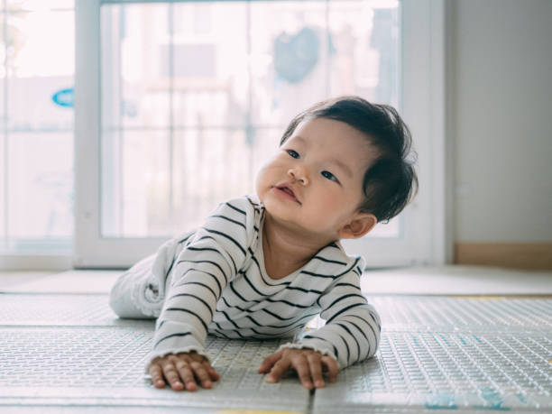 istock Baby boy smiling and laughing on the mat. 1209313286