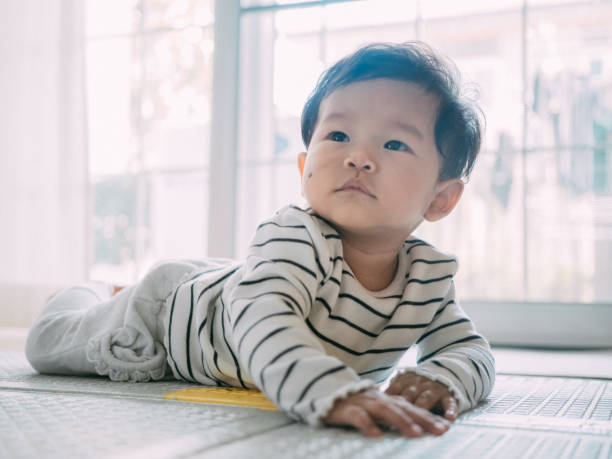 istock Baby boy smiling and laughing on the mat. 1209313338