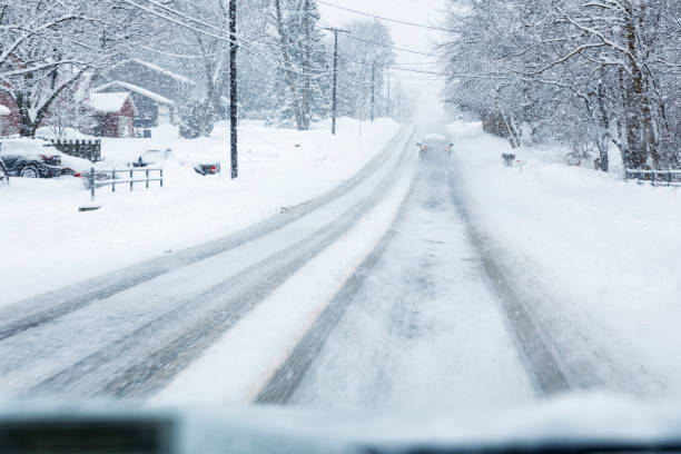 istock Uphill Rural Highway Car Point of View in Winter Blizzard 1209314897