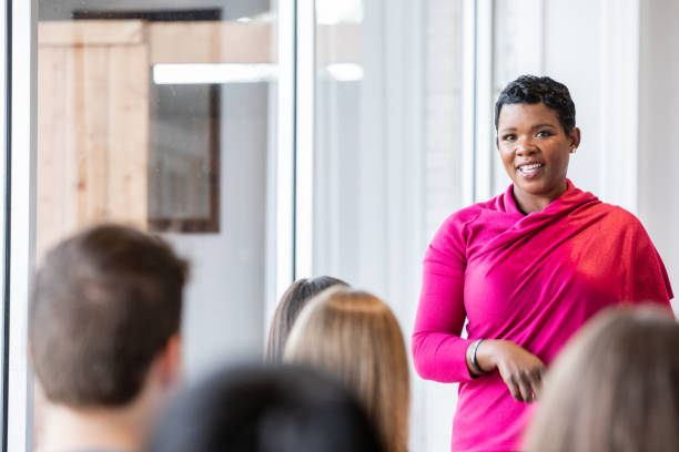 istock Teacher smiles while sharing story with students during a seminar 1209316191