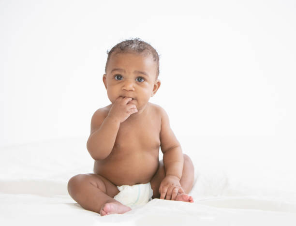 Baby in white background wearing diaper stock photo