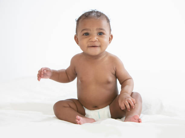 istock Baby in white background wearing diaper 1209317932