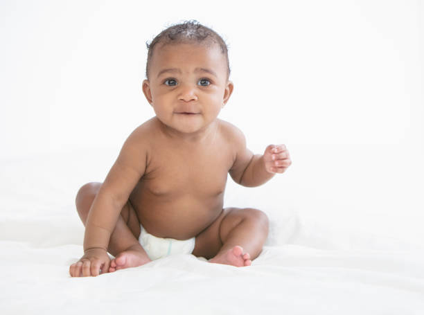 istock Baby in white background wearing diaper 1209317937