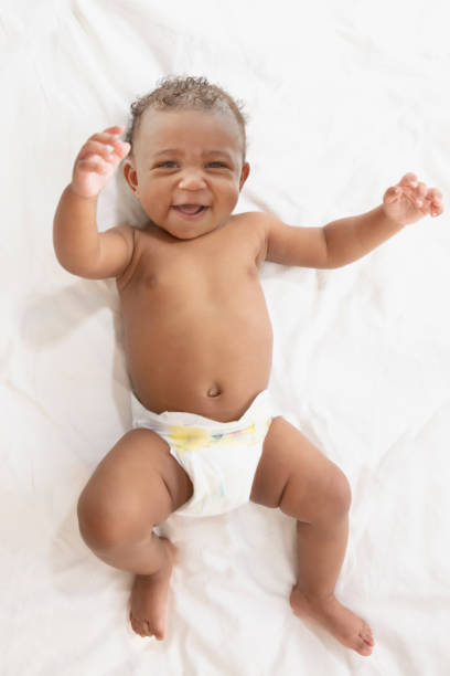 istock Baby in white background wearing diaper 1209317953
