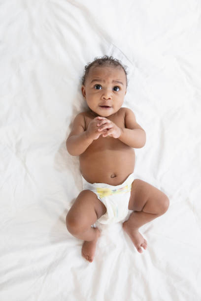 istock Baby in white background wearing diaper 1209317973