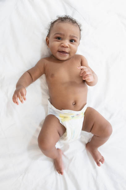 istock Baby in white background wearing diaper 1209317980