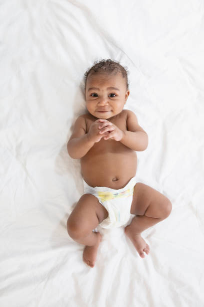 istock Baby in white background wearing diaper 1209317985