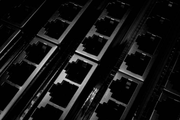 istock Isolated close up closely aligned multiple through hole rj45 ethernet networking hardware connectors in partial focus 1209318071
