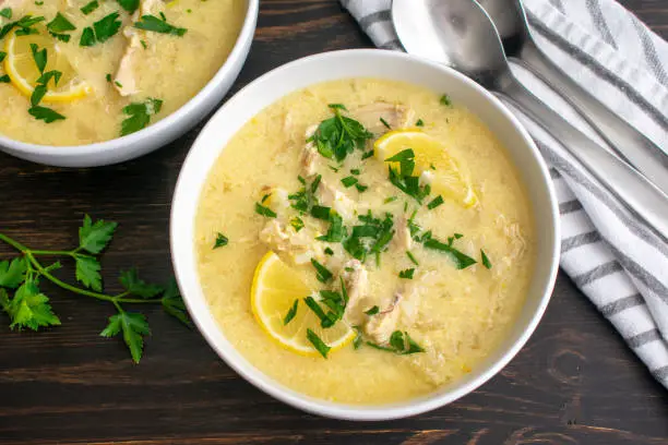 Bowls of traditional Greek soup made with chicken, rice, and lemons