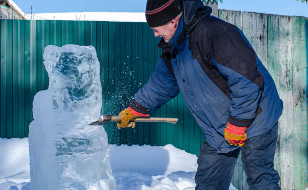 istock man makes frozen ice sculptures with an axe 1209320343