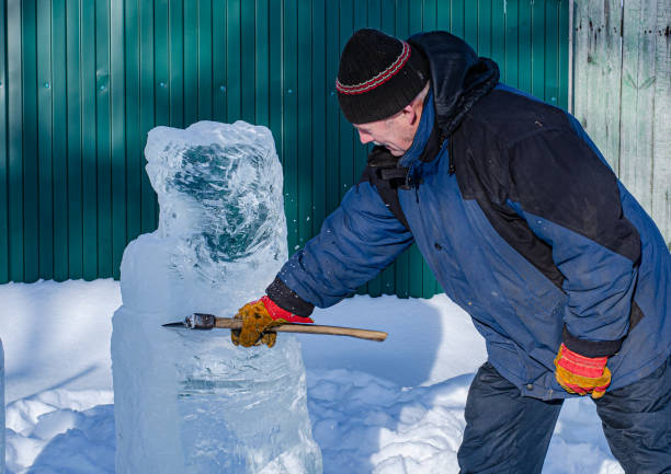istock man makes frozen ice sculptures with an axe 1209320480