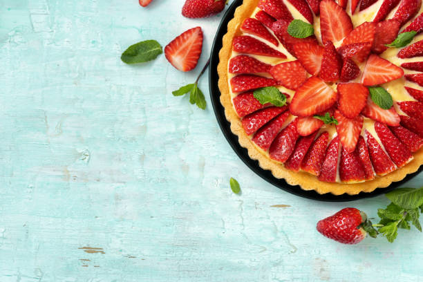 istock Flat lay of strawberry flan cake on light mint background 1209321356