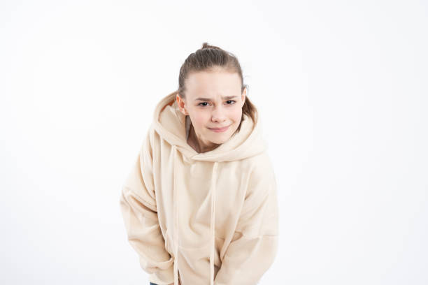istock Image of pleasant looking self assured woman with serious expression, listens information attentively, dressed in hoodie, isolated over white background 1209322040
