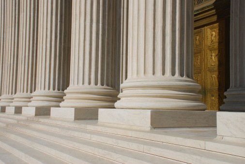 Bronze door, steps and columns at he U.S. Supreme Court building in Washington DC