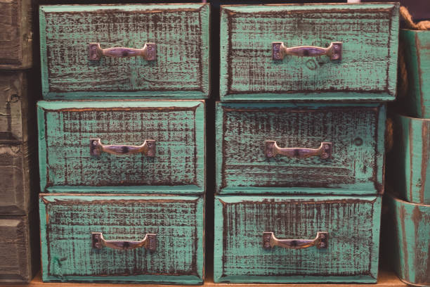 istock Vintage colored and toned wooden drawers background 1209323904