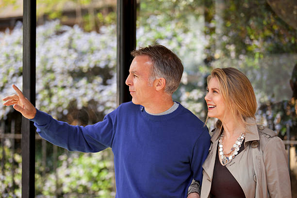 istock mature couple standing at bus stop 120932445