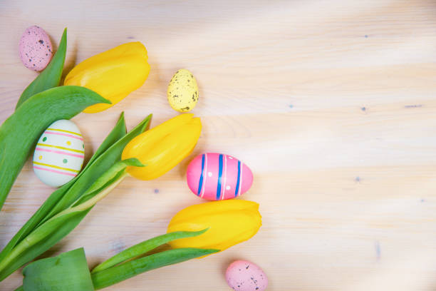 Easter composition with sweet bread, Easter cake, eggs, bouquet of flowers. Holidays breakfast concept with copy space. Traditional easter cake with gingerbread cookies. Easter Greeting Card Template.
