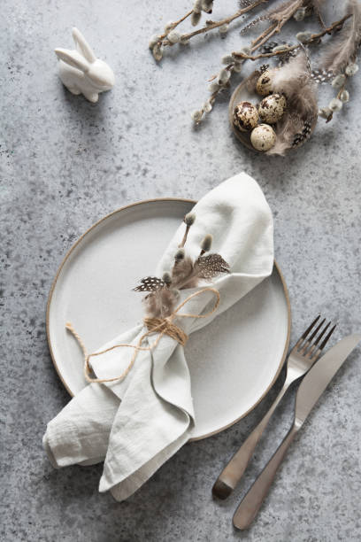 istock Easter pastel holiday table setting with bunny on grey stone table. Top view. 1209328015