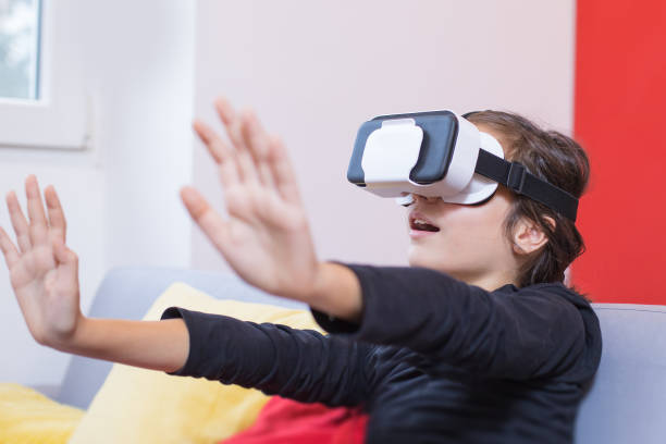 istock young girl looking through VR goggles 1209329155
