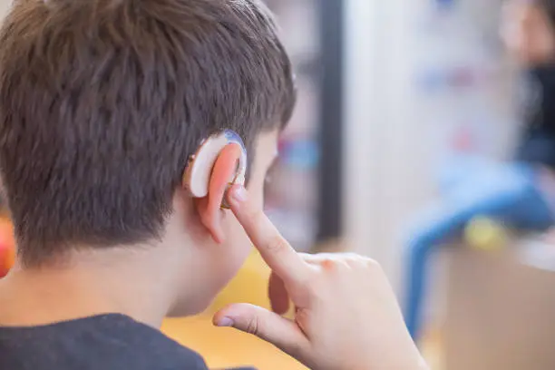 Photo of young boy using hearing aid