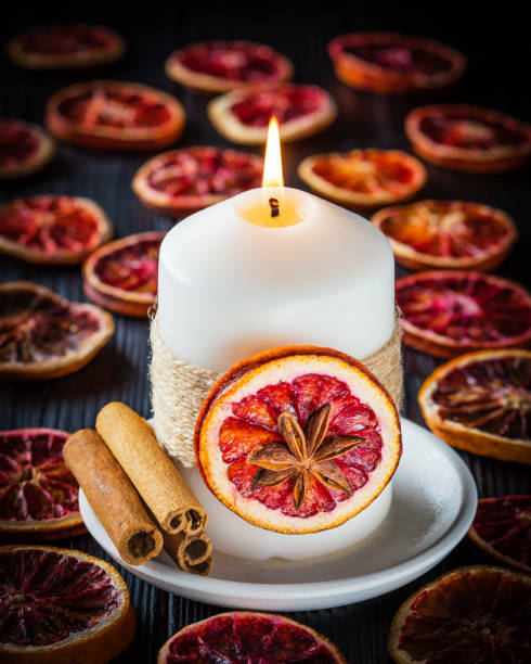 istock Christmas decoration with candle, dried oranges and cinnamon 1209332253