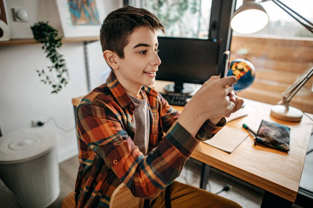 istock Teenage boy using smart phone to send text message 1209337525