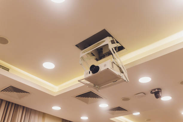 istock Old and dirty projector hang on ceiling in meeting room, education concept. 1209341714