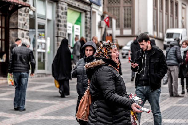Bursa, Turkey - December 27, 2019: Unidentified Turkish lady selling band aids in the street around the Covere Bazaar of Bursa, Turley