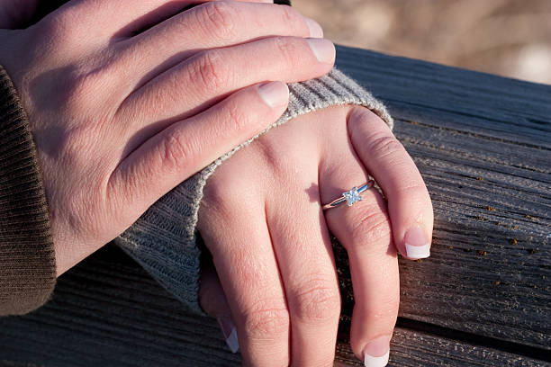 istock Man and Woman Hands with Diamond Engagement Ring Close Up 120934401