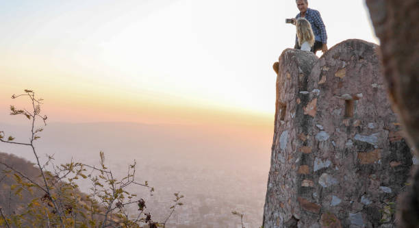 istock Mature couple look off from castle wall at sunrise 1209345727