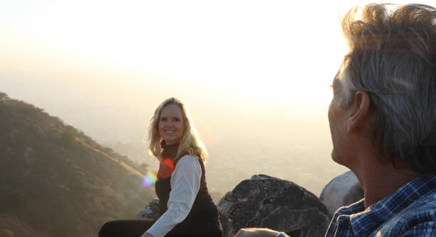 istock Mature couple look off from castle wall at sunrise 1209345755