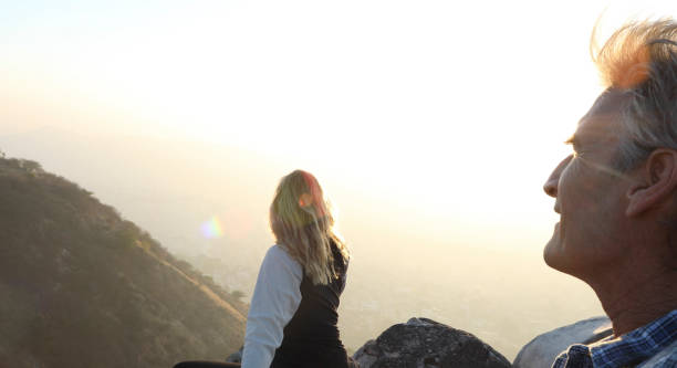 istock Mature couple look off from castle wall at sunrise 1209345784