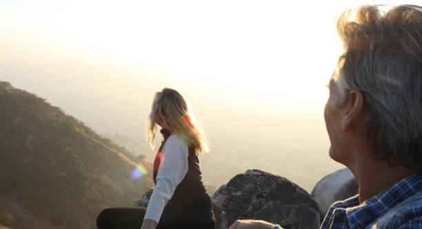 istock Mature couple look off from castle wall at sunrise 1209345808