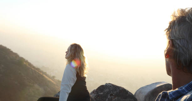 istock Mature couple look off from castle wall at sunrise 1209345815