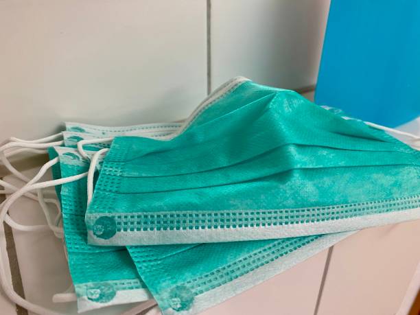 istock Stack of Protective masks and disinfectant bottle 1209346669