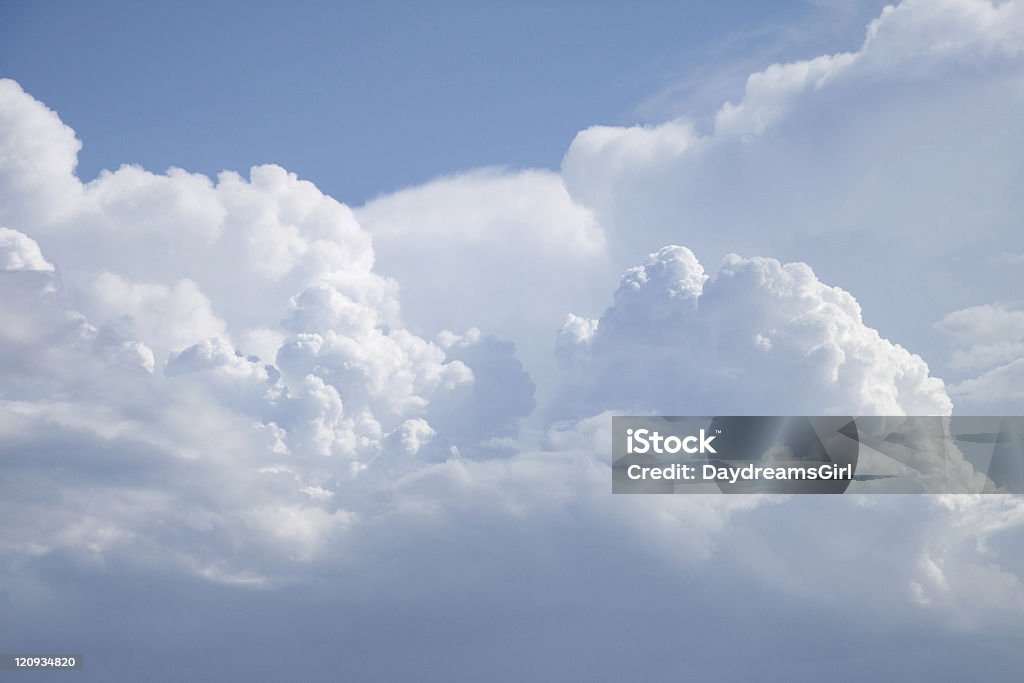 Dramatic Cumulus Clouds and Sky Fluffy cumulus clouds and blue sky. Aerial View Stock Photo