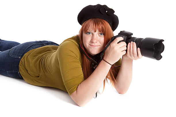 Happy Female Photographer with Camera Isolated on White