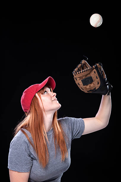 istock Female Baseball Player with Cap and Mitt Catching Ball 120935039