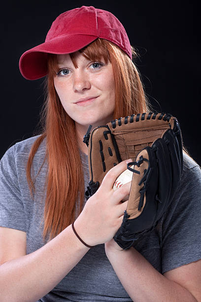 istock Female Baseball Player Wearing Cap with Mitt and Ball 120935046