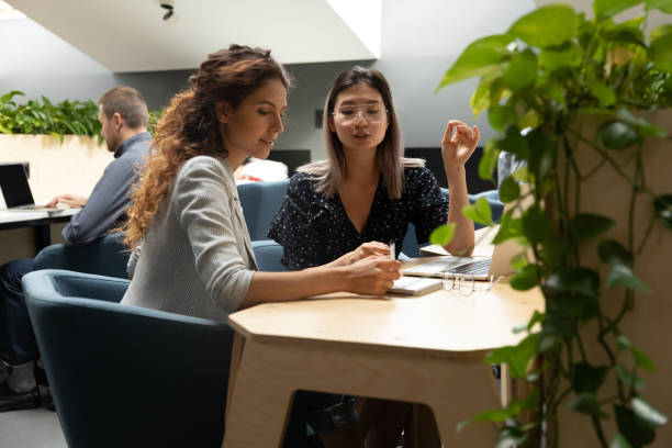 istock Multiethnic female employees busy cooperating in office 1209353294