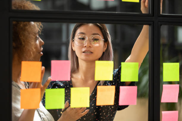 istock Asian female employee work with sticky notes in office 1209353331
